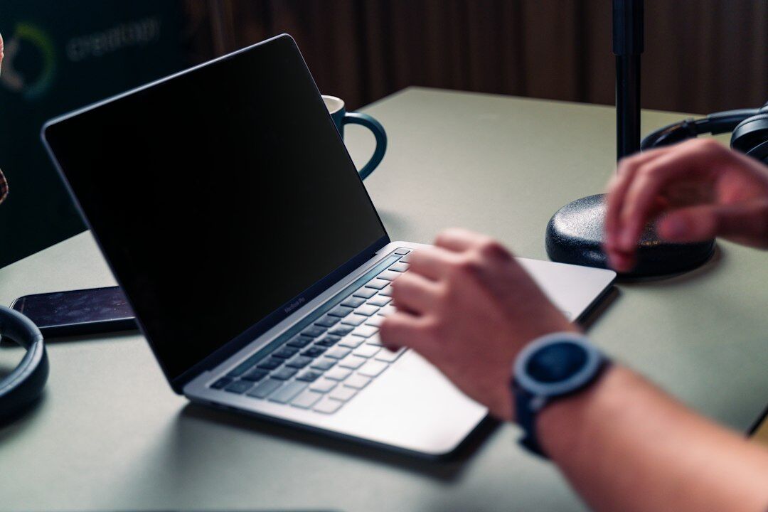 author typing on laptop